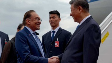 Malaysian PM Anwar Ibrahim warned against "economic tribalism" in a veiled swing to Washington, praising Xi Jinping's conduct as a model of steadiness.