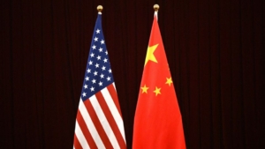 China's and USA's flags at the Guangdong Zhudao Guest House in Guangzhou, on April 5, 2024. A new Pew Research Center survey reveals a surprising shift: in many Global South middle-income countries, people are more concerned about U.S. influence than China’s. (Photo by Pedro Pardo / AFP)