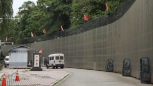 A yellow border wall, about 10 meters high and 170 kilometers long, was erected along the China-Myanmar border in the Jiegao Border Trade Zone in Ruili. This wall, a legacy of the pandemic lockdown, was once described by then-mayor of Ruili, Shang Labian, as a "Great Wall of Steel." (Photo by Fan Shan)