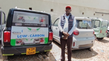 Peter Kihara poses with some of the electric vehicles that the Teachers Transporters Agency is selling in Kenya. The company offers customized solutions that align with customers’ needs, including battery ownership of electric motorcycles. Photo / Njenga Hakeenah / CGSP