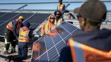 Workers install solar panels onto frames during construction at South Africa's first municipally owned solar plant on June 5, 2025, in Atlantis. Solar is currently generating 8 percent of South Africa’s electricity, a shift driven by aging coal plants and an overstretched transmission system. Photo / RODGER BOSCH / AFP