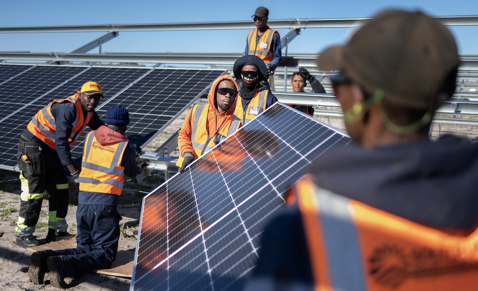 Workers install solar panels onto frames during construction at South Africa's first municipally owned solar plant on June 5, 2025, in Atlantis. Solar is currently generating 8 percent of South Africa’s electricity, a shift driven by aging coal plants and an overstretched transmission system. Photo / RODGER BOSCH / AFP