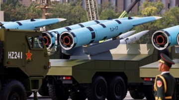 A member of the People's Liberation Army stands as YJ-17 hypersonic anti-ship missiles are displayed during a military parade to mark the 80th anniversary of the end of World War Two, in Beijing, China, September 3, 2025. Iran is close to a deal with China to purchase anti‑ship cruise missiles just as the United States deploys a vast naval force near the Iranian coast. REUTERS/Tingshu Wang