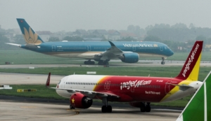 An airplane of VietJet Airline taxis in front of the national flag carrier Vietnam Airlines airplane, at Noi Bai International Airport, in Hanoi, Vietnam, May 28, 2025. REUTERS/Chalinee Thirasupa