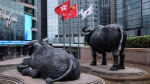 Bull statues near screens showing the Hang Seng stock index and stock prices outside Exchange Square, in Hong Kong, China, February 3, 2026. REUTERS/Tyrone Siu