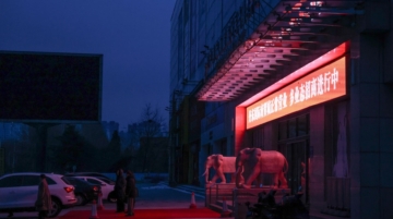 People stand next to the entrance of a closed shopping mall in Dandong, a city on the border with North Korea, in Liaoning province, China, January 14, 2026. REUTERS/Maxim Shemetov