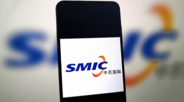 An illustration photo shows SMIC logo in a smartphone in Suqian, Jiangsu Province, China on November 6, 2025. Photo by Guo Dexin / CFOTO via AFP