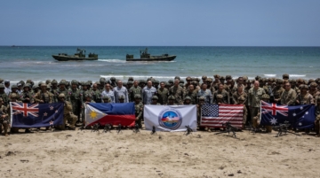 Troops from New Zealand, Philippines, U.S., and Australia pose for a photo with their national flags after participating in counter-landing live fire exercises during Balikatan, the annual joint military exercises between the U.S. and the Philippines, at Long Point Beach, Brgy. Aporawan, Aborlan, Palawan, Philippines, April 27, 2026. REUTERS/Eloisa Lopez