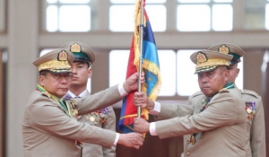FILE PHOTO: Myanmar junta chief Senior General Min Aung Hlaing hands over a flag to newly appointed Commander-in-Chief General Ye Win Oo during a ceremony in Naypyitaw, Myanmar, March 30, 2026. Myanmar Military True News Information Team/Handout via REUTERS ATTENTION EDITORS - THIS IMAGE HAS BEEN SUPPLIED BY A THIRD PARTY./File Photo