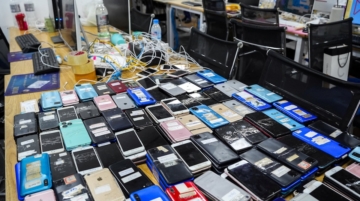 Mobile phones seized by police during an online scam crackdown at a hotel in Phnom Penh, Cambodia, March 11, 2026. REUTERS/Roun Ry