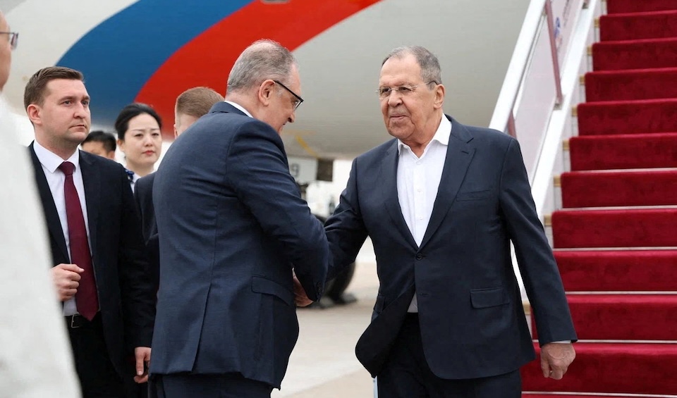 Russian Foreign Minister Sergei Lavrov shakes hands with Igor Morgulov, Russia's Ambassador to China, upon arrival at the airport in Beijing, China April 14, 2026. Russian Foreign Ministry/Handout via REUTERS ATTENTION EDITORS - THIS IMAGE WAS PROVIDED BY A THIRD PARTY. NO RESALES. NO ARCHIVES. MANDATORY CREDIT.