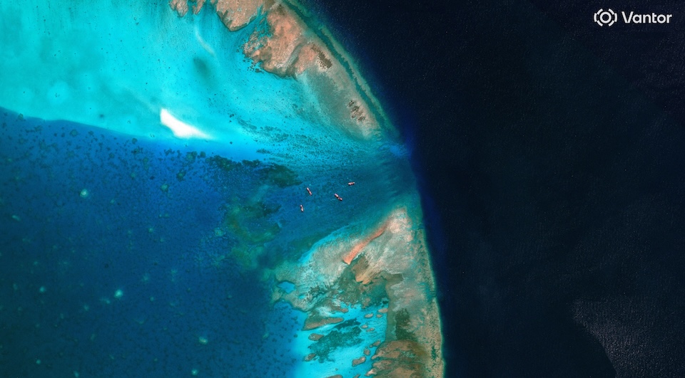 A satellite image of fishing vessels at the entrance, which is blocked by a floating barrier, to the disputed Scarborough Shoal, in the South China Sea, April 11, 2026. Vantor/Handout via REUTERS THIS IMAGE HAS BEEN SUPPLIED BY A THIRD PARTY. MANDATORY CREDIT. NO RESALES. NO ARCHIVES. MUST NOT OBSCURE LOGO.