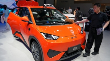 A staff member dusts a BYD Seagull electric vehicle (EV) displayed at the Beijing International Automotive Exhibition, or Auto China, in Beijing, China April 26, 2026. REUTERS/Xiaoyu Yin