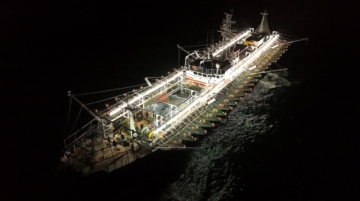 A drone view shows crew members aboard a squid jigger vessel operating outside Argentina's exclusive economic zone, where foreign fishing vessels, mostly Chinese, operate just beyond the boundary, in the South Atlantic Ocean off the coast of Argentina, January 18, 2026. REUTERS/Agustin Marcarian