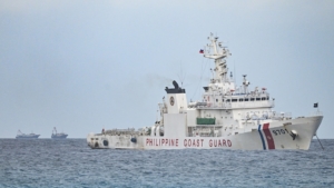 A Philippine Coast Guard ship is seen near Thitu Island in the South China Sea on February 21, 2026. A Philippine senator called for deepening defence relationships and "continuous" pushback against China's claims in the South China Sea while visiting one of Manila's tiny possessions in the disputed waterway on February 21. (Photo by Jam STA ROSA / AFP)